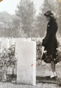 Angela standin at the grave of her father